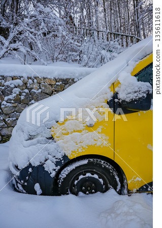 Front of Yellow Bus Covered in Snow on Winter Street Front of Yellow Bus Covered in Snow on Winter Street 135611618