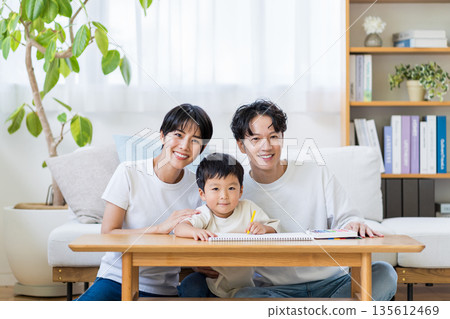 A family relaxing in the living room. A family relaxing in the living room. 135612469