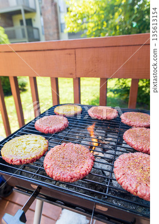 A grill with hamburgers on it A grill with hamburgers on it 135613154