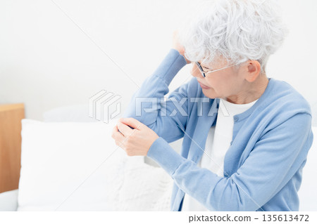 Senior woman with elbow pain Senior woman with elbow pain 135613472