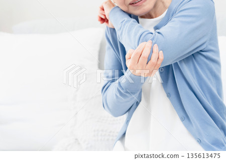 Senior woman with elbow pain Senior woman with elbow pain 135613475