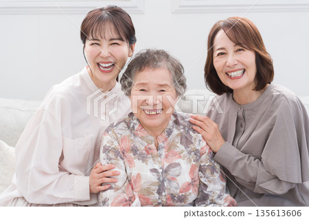 Smiling female three generation family Smiling female three generation family 135613606