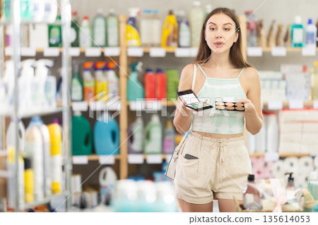 Woman view trademark sign on label, chooses eco friendly cosmetic pallet Woman view trademark sign on label, chooses eco friendly cosmetic pallet 135614053