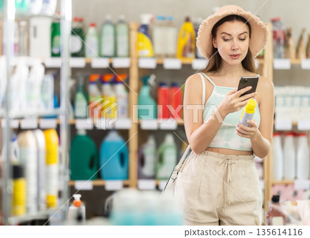 woman scans an insect repellent barcode on her phone woman scans an insect repellent barcode on her phone 135614116