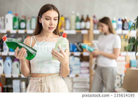 Woman choosing dishwashing detergent in supermarket Woman choosing dishwashing detergent in supermarket 135614195