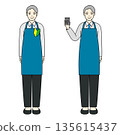A senior man in an apron wearing a beginner's mark and holding a calculator to guide 135615437