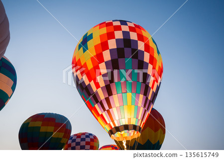 colorful hot air balloons glowing against sky 135615749