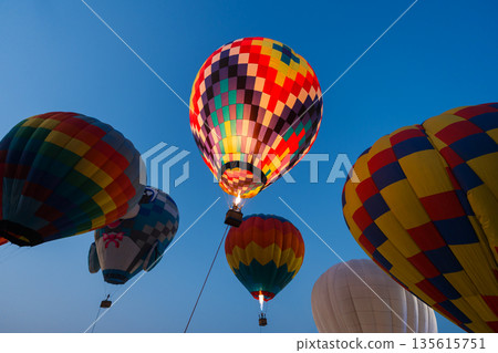 colorful hot air balloons glowing against sky colorful hot air balloons glowing against sky 135615751