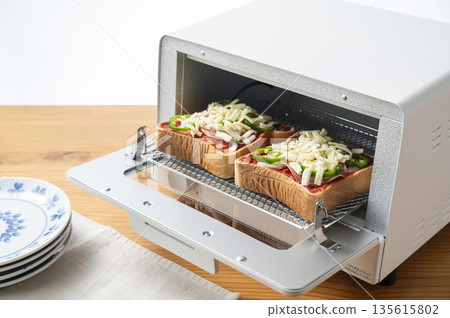 Baking pizza toast in a toaster oven Before baking 135615802