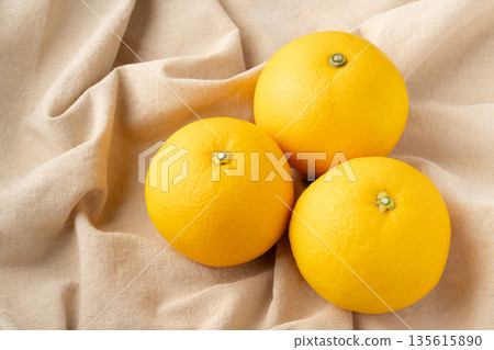 Three hassaku oranges placed on a cloth Three hassaku oranges placed on a cloth 135615890