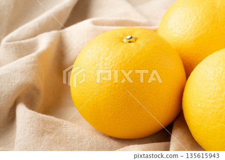 Delicious-looking hassaku oranges placed on a cloth 135615943