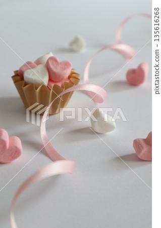 Cute heart-shaped marshmallows and ribbon 135616268