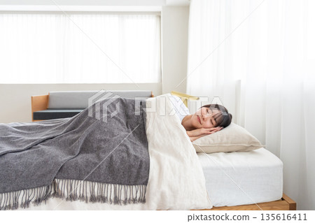 一個睡在床上的年輕女人 135616411
