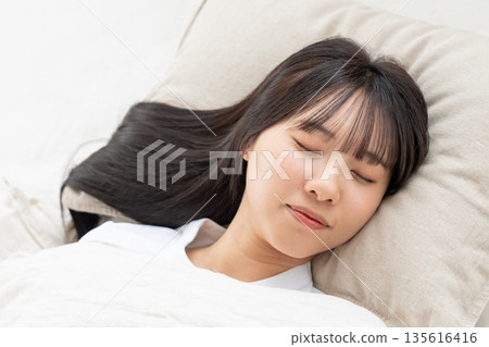 A young woman sleeping in bed A young woman sleeping in bed 135616416