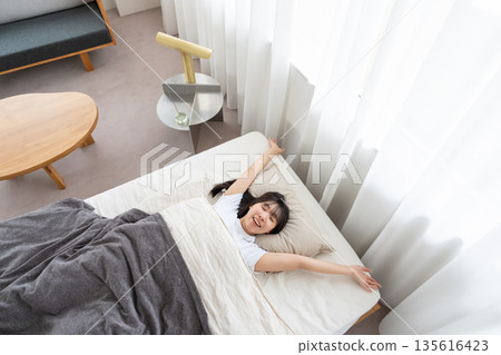 A woman stretching in bed 135616423