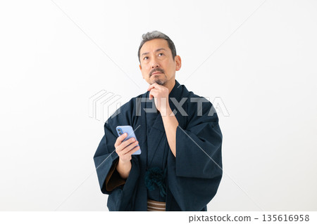 Men looking at smartphones Men looking at smartphones 135616958