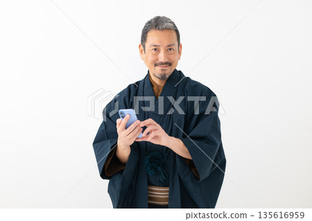 Men looking at smartphones Men looking at smartphones 135616959