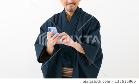 Men looking at smartphones Men looking at smartphones 135616960