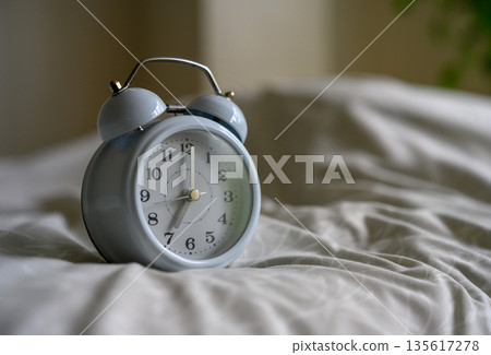 Alarm clock on the bed Alarm clock on the bed 135617278