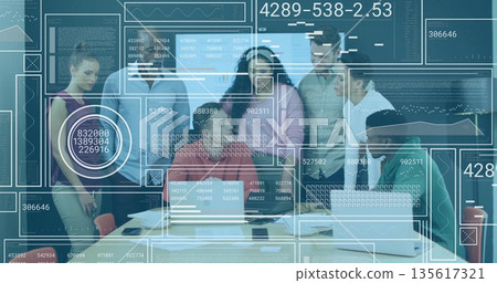 Collaborating team members reviewing data on display in office meeting room, with laptops, overlays 135617321