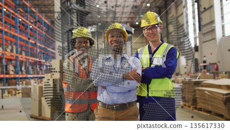 Standing warehouse workers crossing arms in warehouse, with hard hats, safety vests and pallets 135617330