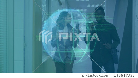 Colleagues walking down office hallway using smartphone under holographic code globe 135617353