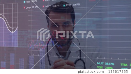 Doctor analyzing overlaid charts with percentage labels on display in lab at desk, with stethoscope Doctor analyzing overlaid charts with percentage labels on display in lab at desk, with stethoscope 135617365