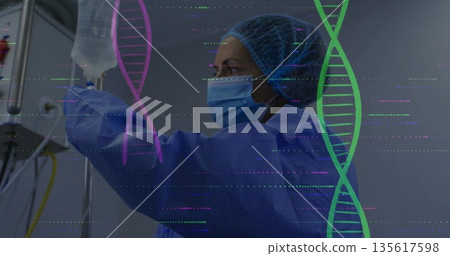 Female medical worker wearing surgical gown adjusting IV bag at clinic, with DNA overlay 135617598