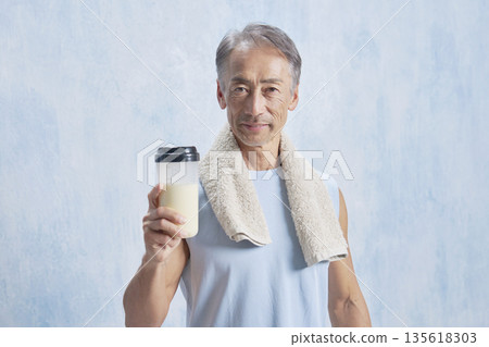 Senior man training with a protein bottle, looking at the camera Senior man training with a protein bottle, looking at the camera 135618303