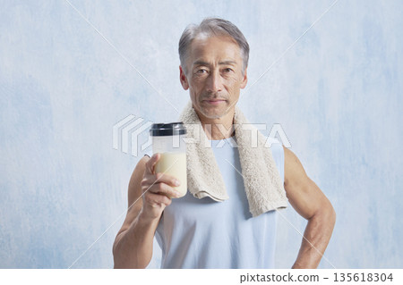 Senior man training with a protein bottle, looking at the camera 135618304