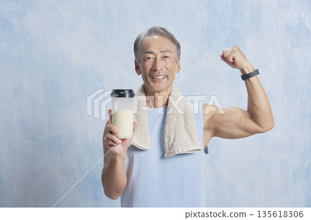 Senior man training with a protein bottle, fist pump 135618306