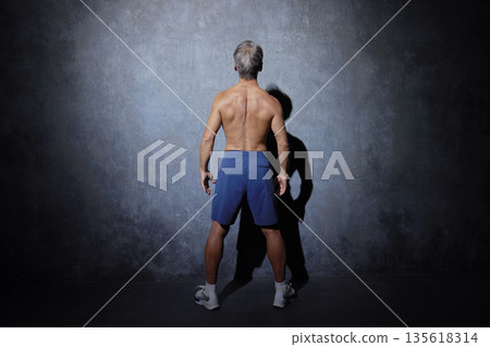 Muscular senior man posing, back view Muscular senior man posing, back view 135618314