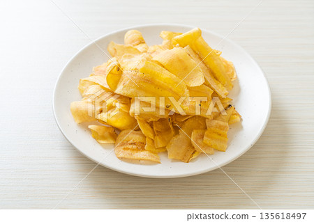 Banana Chips - fried or baked sliced banana Banana Chips - fried or baked sliced banana 135618497