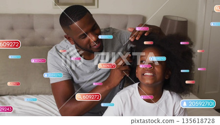 Father combing daughter's hair on bed in bedroom, with hairbrush, tufted headboard and lamp Father combing daughter's hair on bed in bedroom, with hairbrush, tufted headboard and lamp 135618728