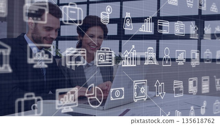 Reviewing business professionals working on laptop in modern office, with finance charts overlaying Reviewing business professionals working on laptop in modern office, with finance charts overlaying 135618762