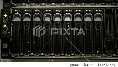 Server storage array displaying drive caddies with LED lights in data center rack, with empty bay 135618775