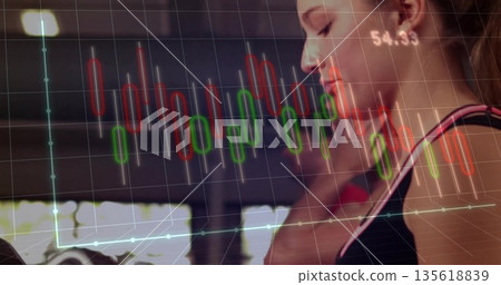 Running female athlete in sleeveless top on treadmill at gym, candlestick chart overlay, copy space 135618839
