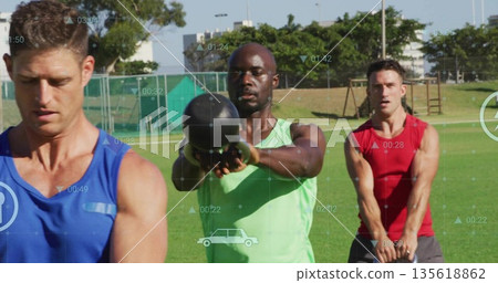 Swinging Black man in green tank top holding kettlebell on grass sports field, with digital metrics Swinging Black man in green tank top holding kettlebell on grass sports field, with digital metrics 135618862