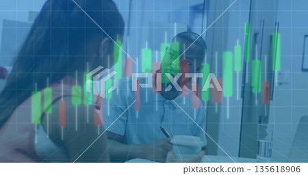Office coworkers discussing financial candlestick chart overlay in kitchen area, with notebook pen 135618906