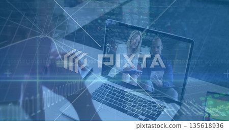 Conducting remote meeting user viewing laptop at office with smartphone tablet and data overlays Conducting remote meeting user viewing laptop at office with smartphone tablet and data overlays 135618936
