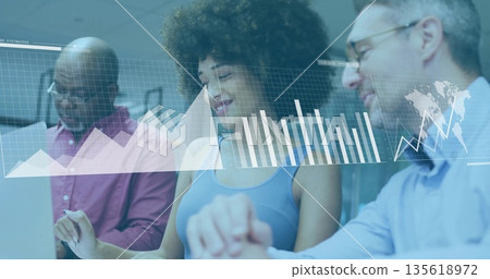 Three professionals reviewing digital charts on transparent display in modern office, with laptop 135618972