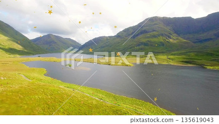 Displaying mountain lake with grassy plains and peaks in highland valley, with golden star overlays Displaying mountain lake with grassy plains and peaks in highland valley, with golden star overlays 135619043