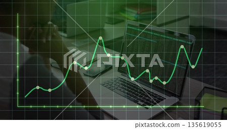 Contemplating man studying code on laptop at office, with smartphone and chart overlay, copy space 135619055