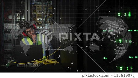 Leaning IT technician in safety vest, earmuffs inspecting laptop cables in server room, copy space Leaning IT technician in safety vest, earmuffs inspecting laptop cables in server room, copy space 135619075
