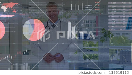 Standing senior doctor displaying digital charts in medical office, with stethoscope, binders plant 135619113