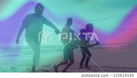 Senior couple in summer clothes walking while holding kids' hands on sandy shore, with ocean water 135619148