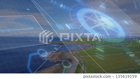 Digital compass dial with grid overlay projecting over rocky shore and green fields, copy space Digital compass dial with grid overlay projecting over rocky shore and green fields, copy space 135619159