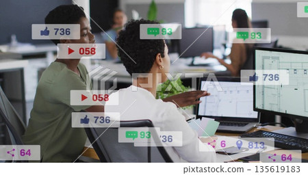 Pointing woman in white blouse showing laptop screen in open-plan office, with social media metrics Pointing woman in white blouse showing laptop screen in open-plan office, with social media metrics 135619183