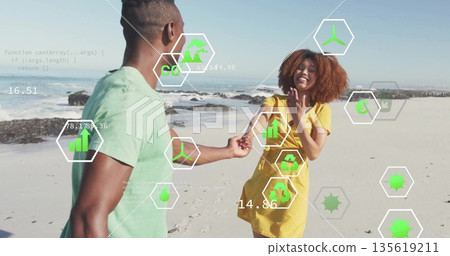 Couple holding hands walking along beach wearing tee and dress, with AR icons showing charts code 135619211