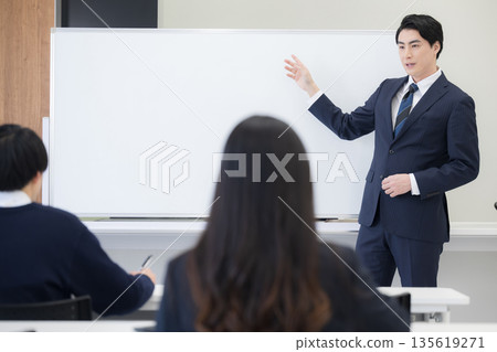 Scenery of a teacher teaching mathematics at a whiteboard and high school students in a classroom or taking exams Scenery of a teacher teaching mathematics at a whiteboard and high school students in a classroom or taking exams 135619271